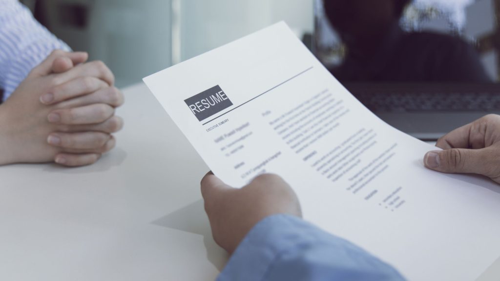 Image of a person holding a resume for Common CV Mistakes Blog Post